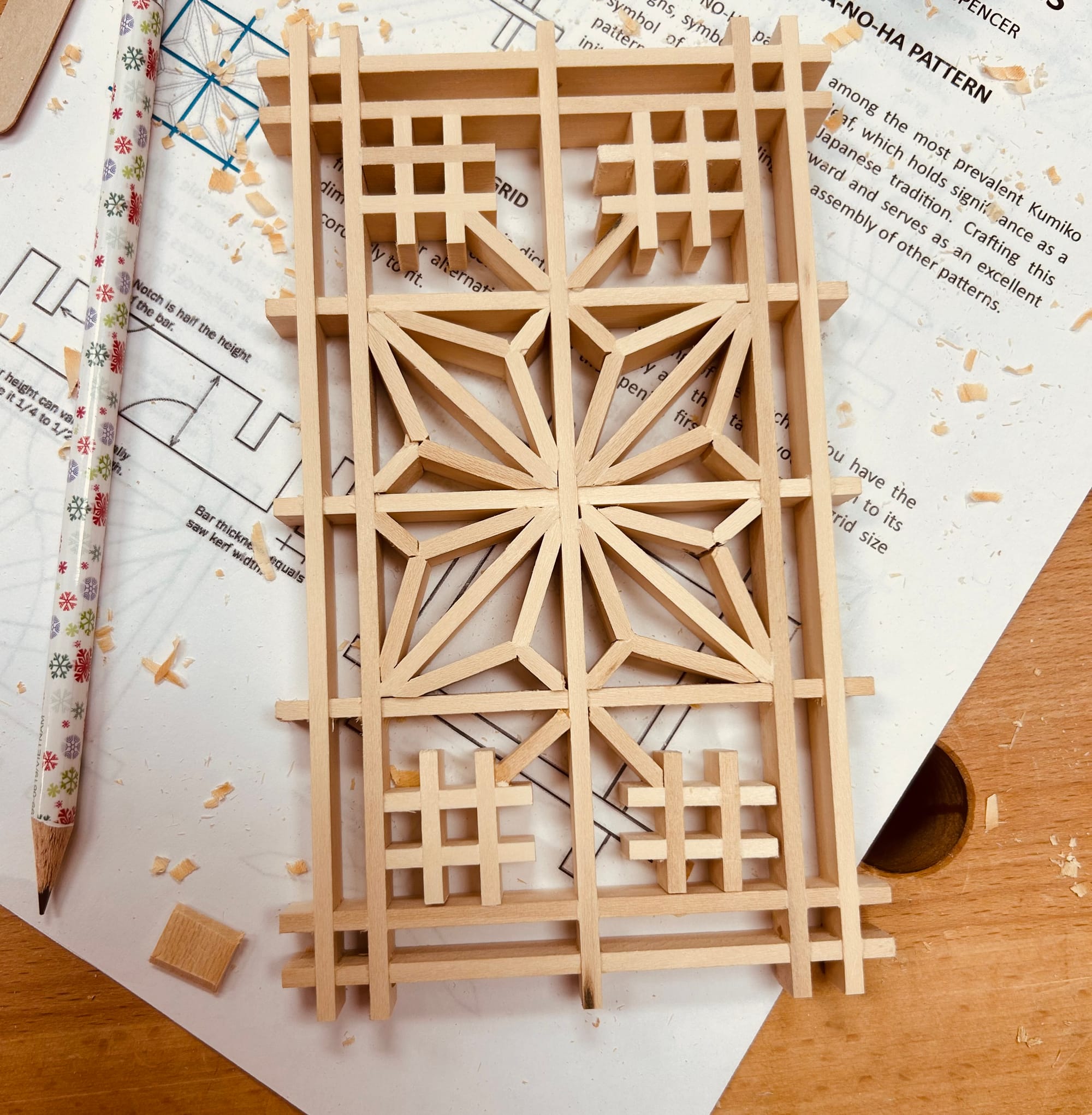 A geometric hemp leaf pattern, made of pieces of wood. 